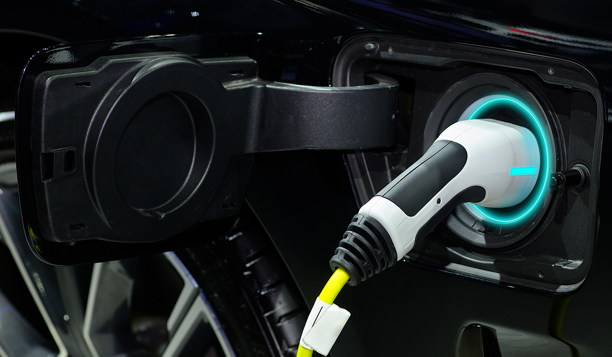 Close-up hand grip plug of industrial electric charging machine connected with socket charge