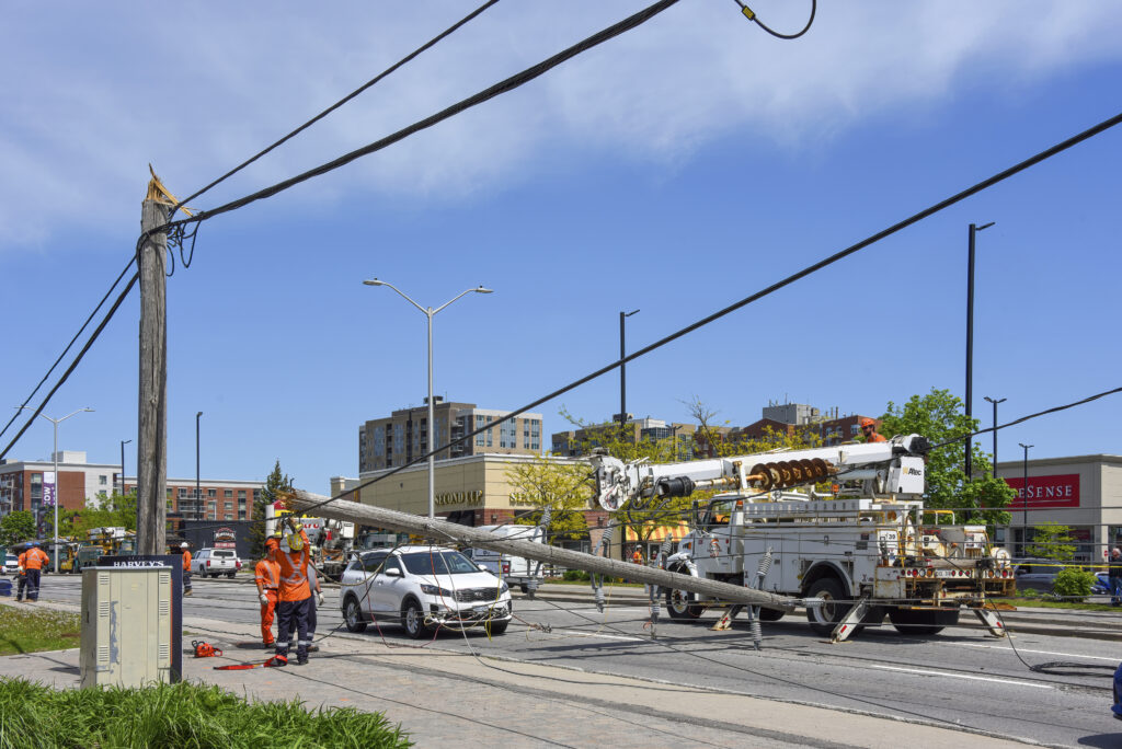 Hydro workers repairing downed power pole snapped by wind in Ottawa after severe storm